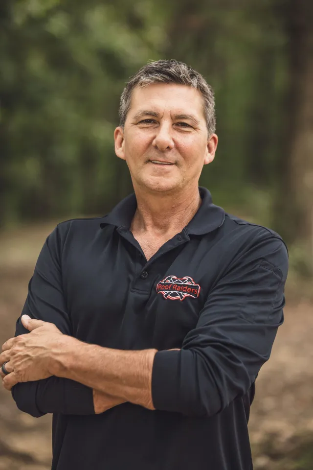 Jeff Kohler smiling with her arms crossed.