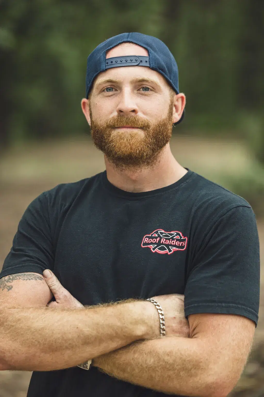 Nick Ferris standing and smiling with his arms crossed.